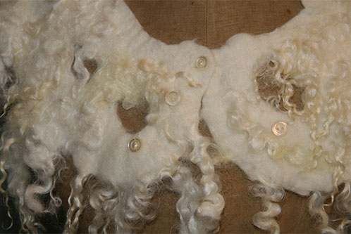 Wollen halssieraad - Merino wol met parelmoeren knoopjes